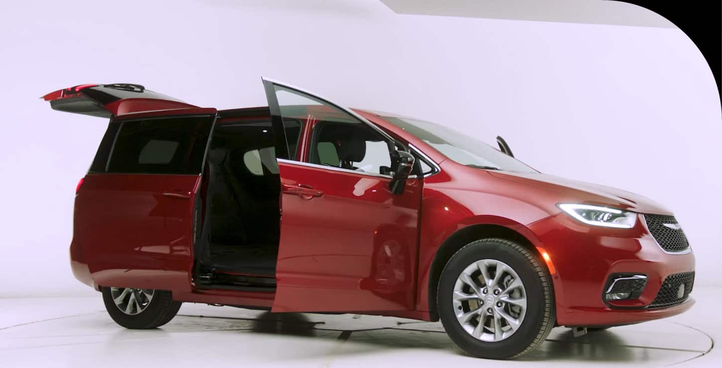 Red 2026 Chrysler Pacifica with its sliding door and liftgate open.