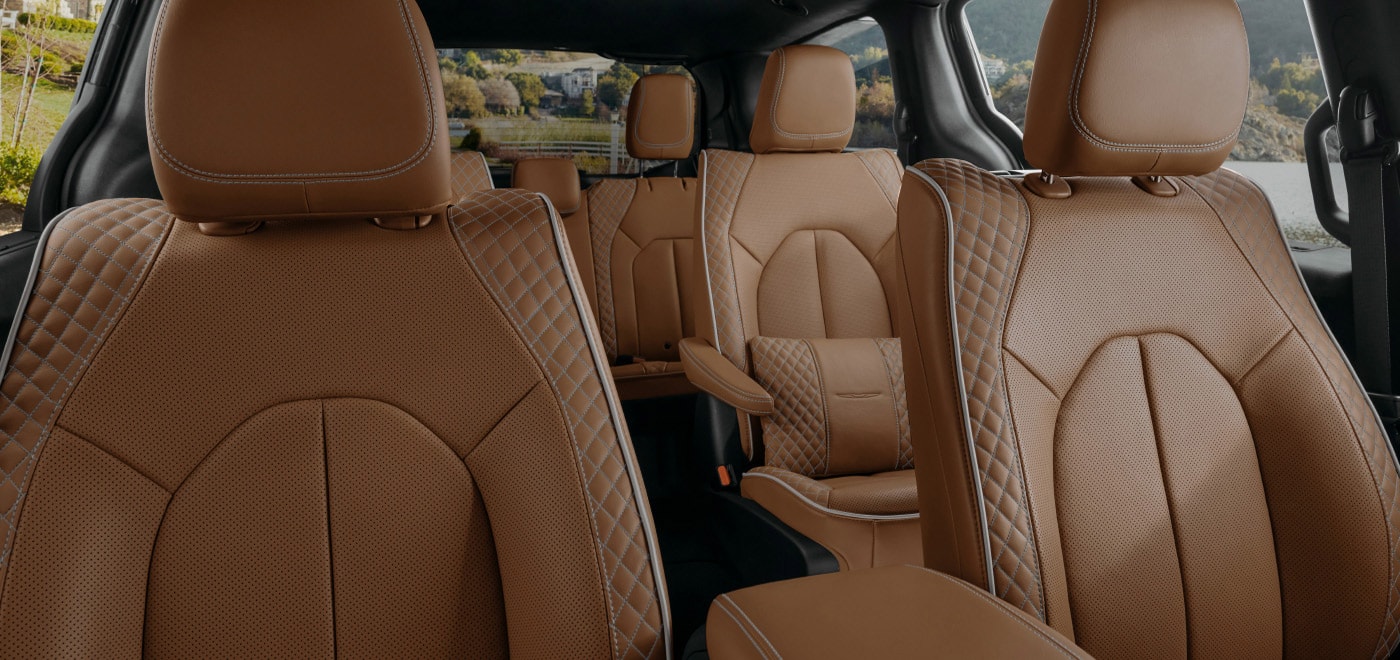 Quilted tan seats across the cabin of a 2026 Chrysler Pacifica.