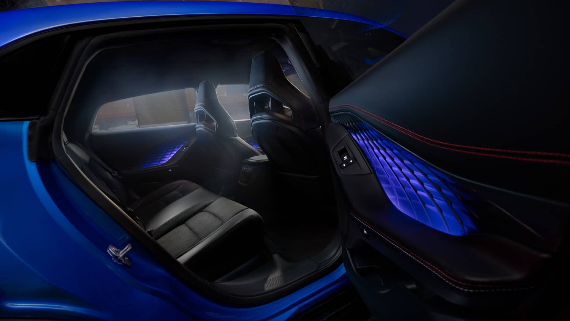 Rear passenger area of a blue 2026 Dodge Charger with ambient door lighting.