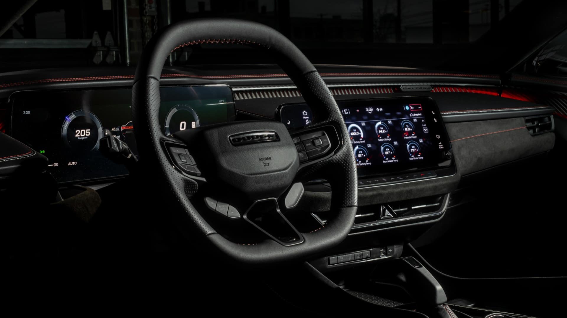 2026 Dodge Charger steering wheel, digital instruments and central touchscreen with red ambient lighting.