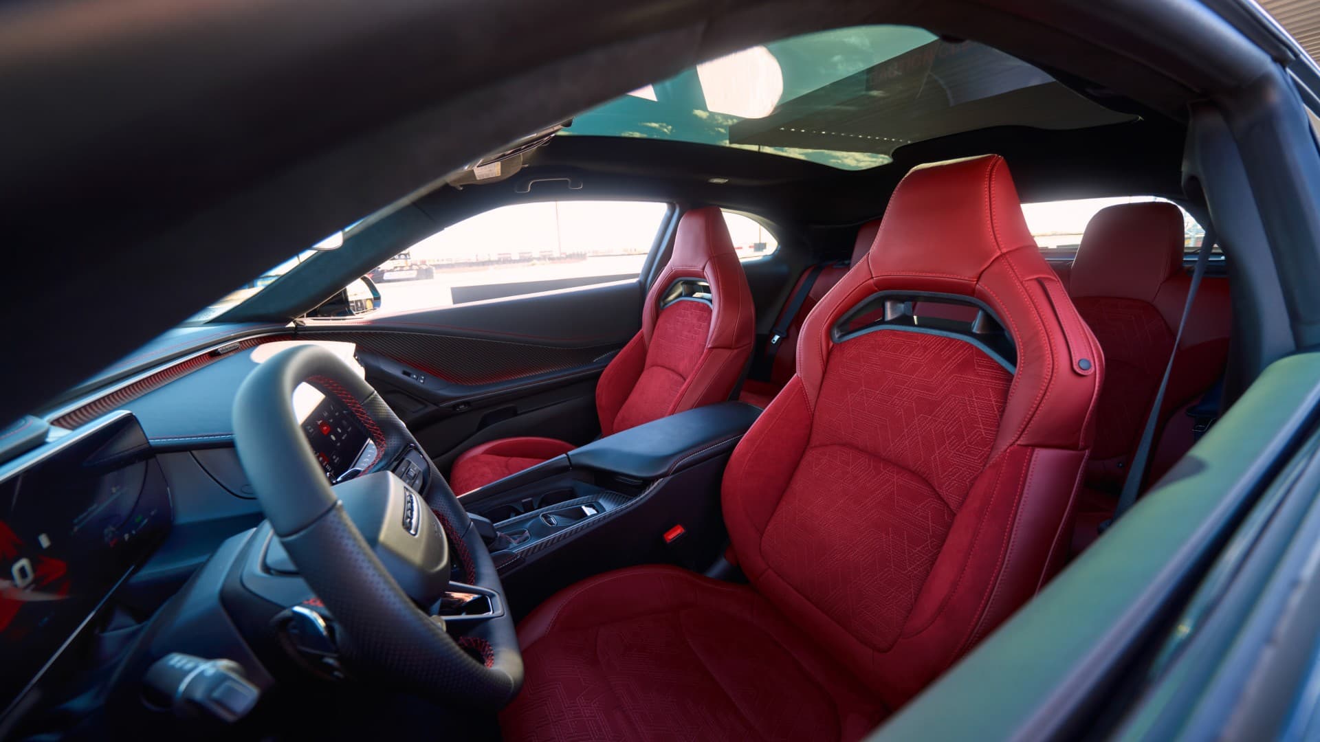 Red performance front seats and driver cockpit in a 2026 Dodge Charger.