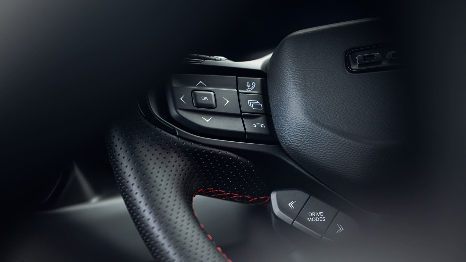 Close-up of 2026 Dodge Charger steering-wheel assistance and drive-mode controls.