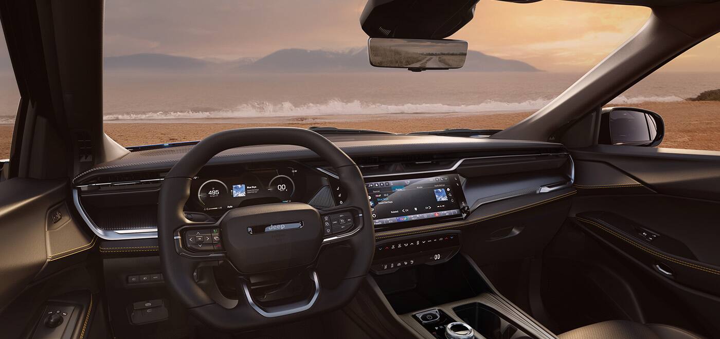 The front seat area of the 2026 Jeep Cherokee focusing on the steering wheel, Digital Cluster Display, Uconnect touchscreen and center console controls.