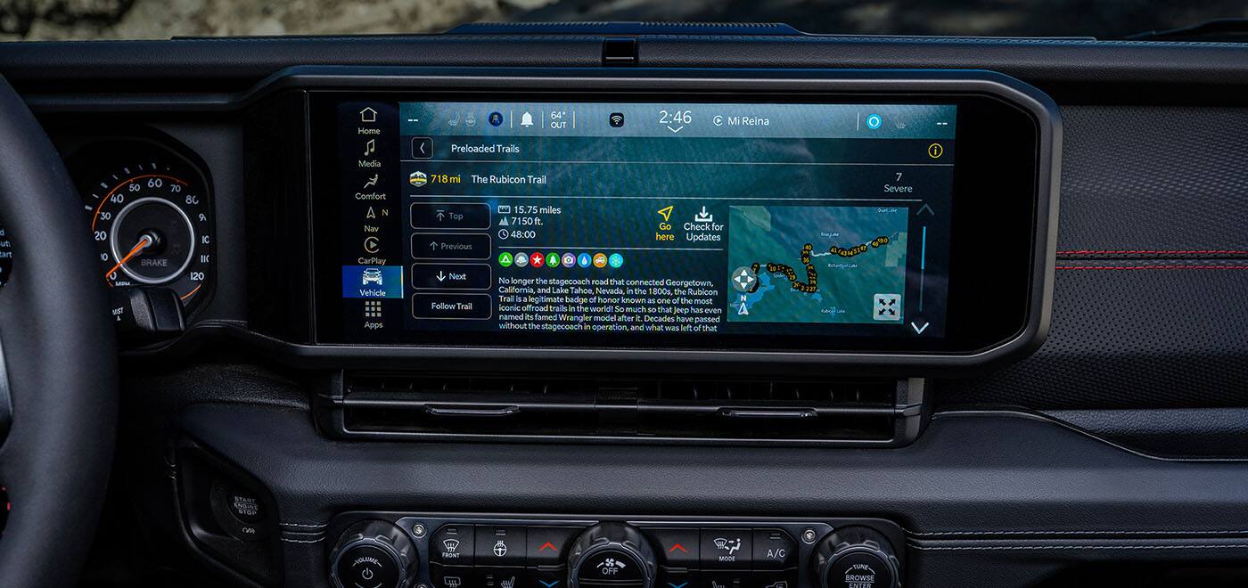 The Uconnect touchscreen in the 2026 Jeep Gladiator displaying one of the Off-Road Adventure Guides with a map and details on the Rubicon trail.