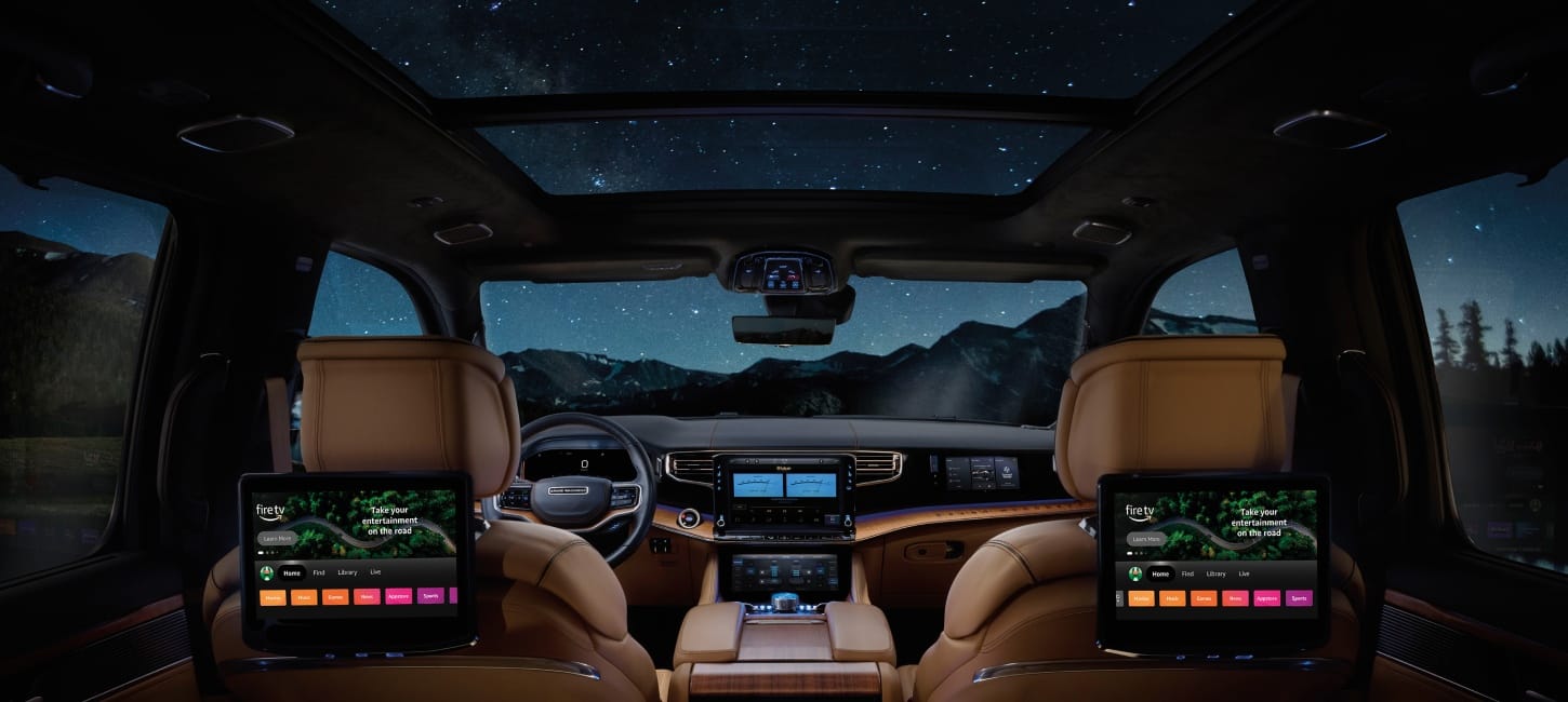 2026 Jeep Grand Wagoneer cabin at night with screens and panoramic roof.