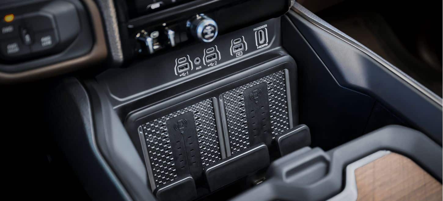 The USB and HDMI ports and dual charging pads in the center console of the 2026 Ram 3500 Limited Longhorn.