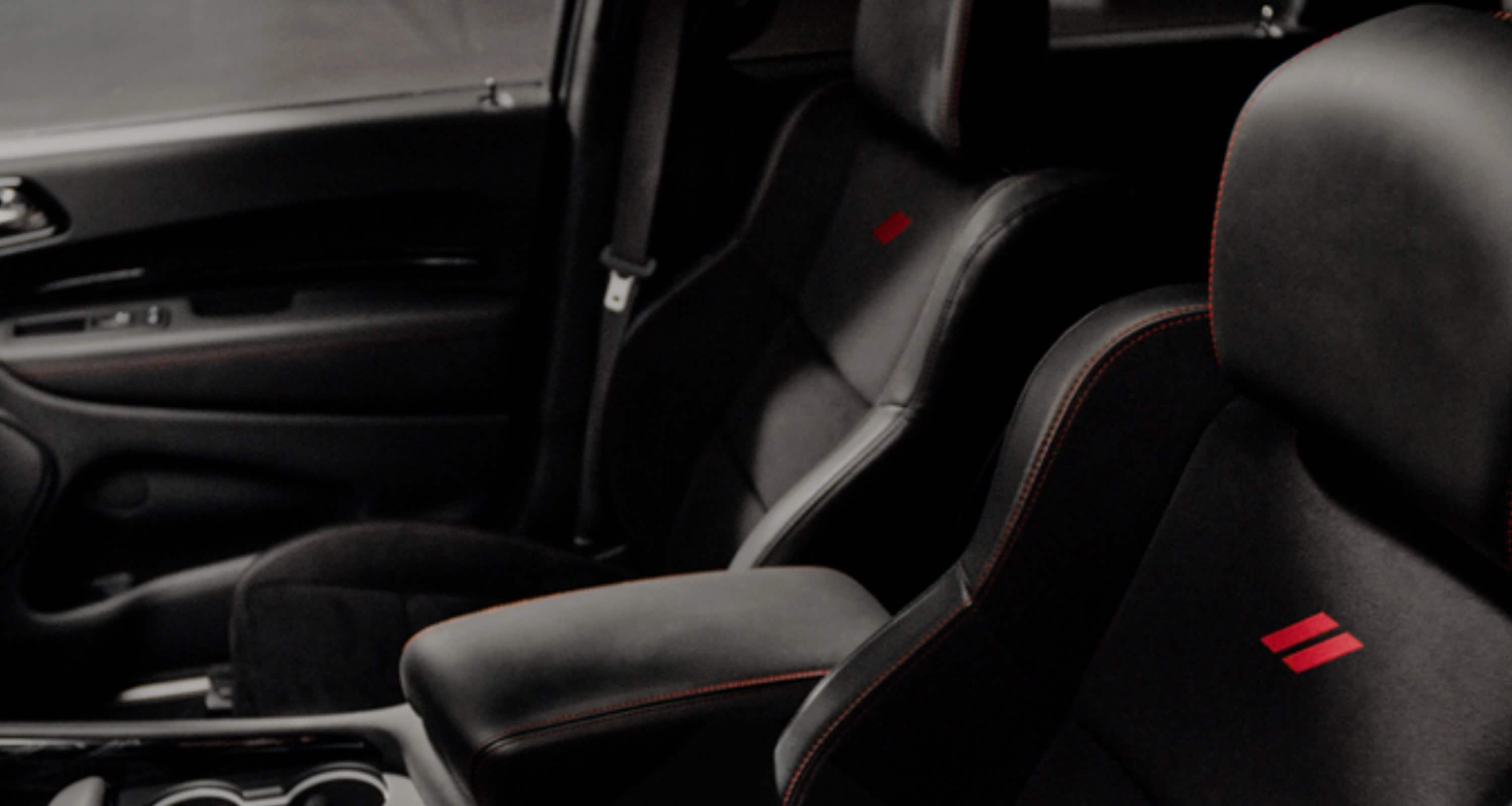The black leather-trimmed front seats with red stitching in a 2027 Dodge Durango R/T 392 Plus.
