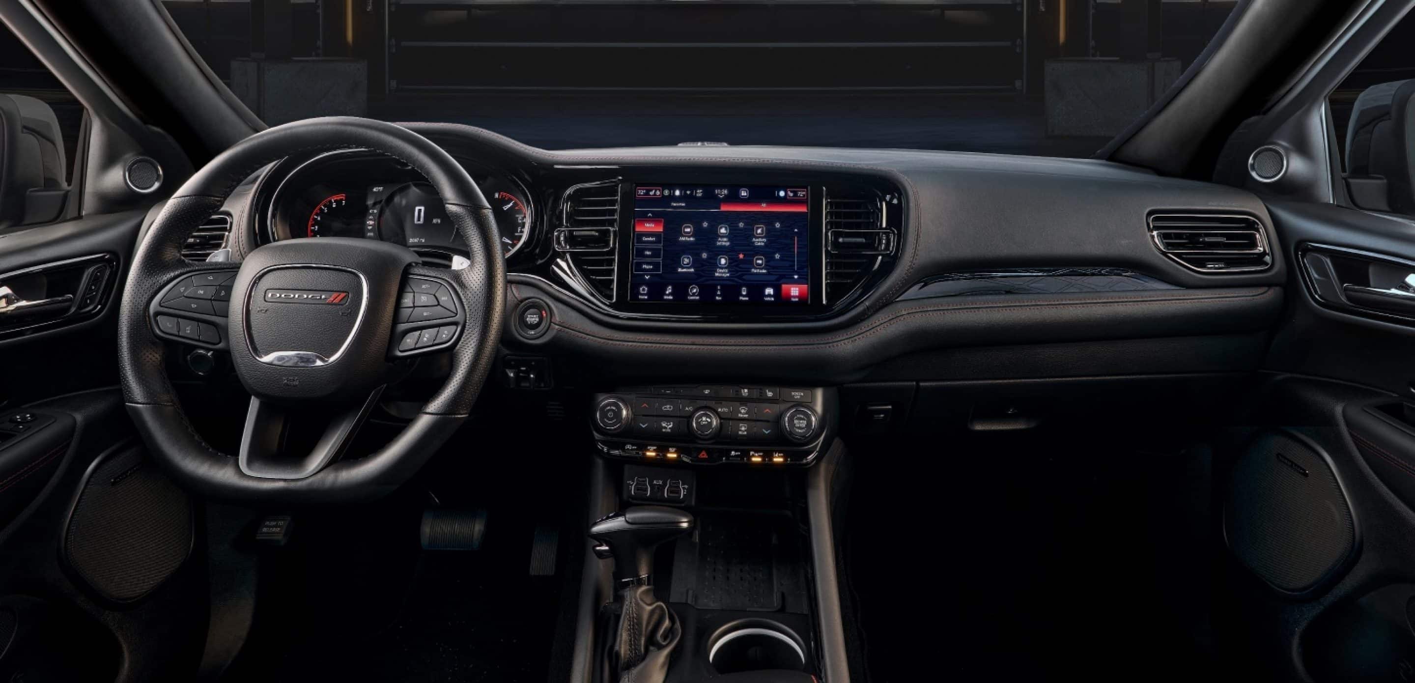 The steering wheel, Digital Cluster, Uconnect touchscreen, center stack controls and center console in a 2027 Dodge Durango GT Hemi V8.