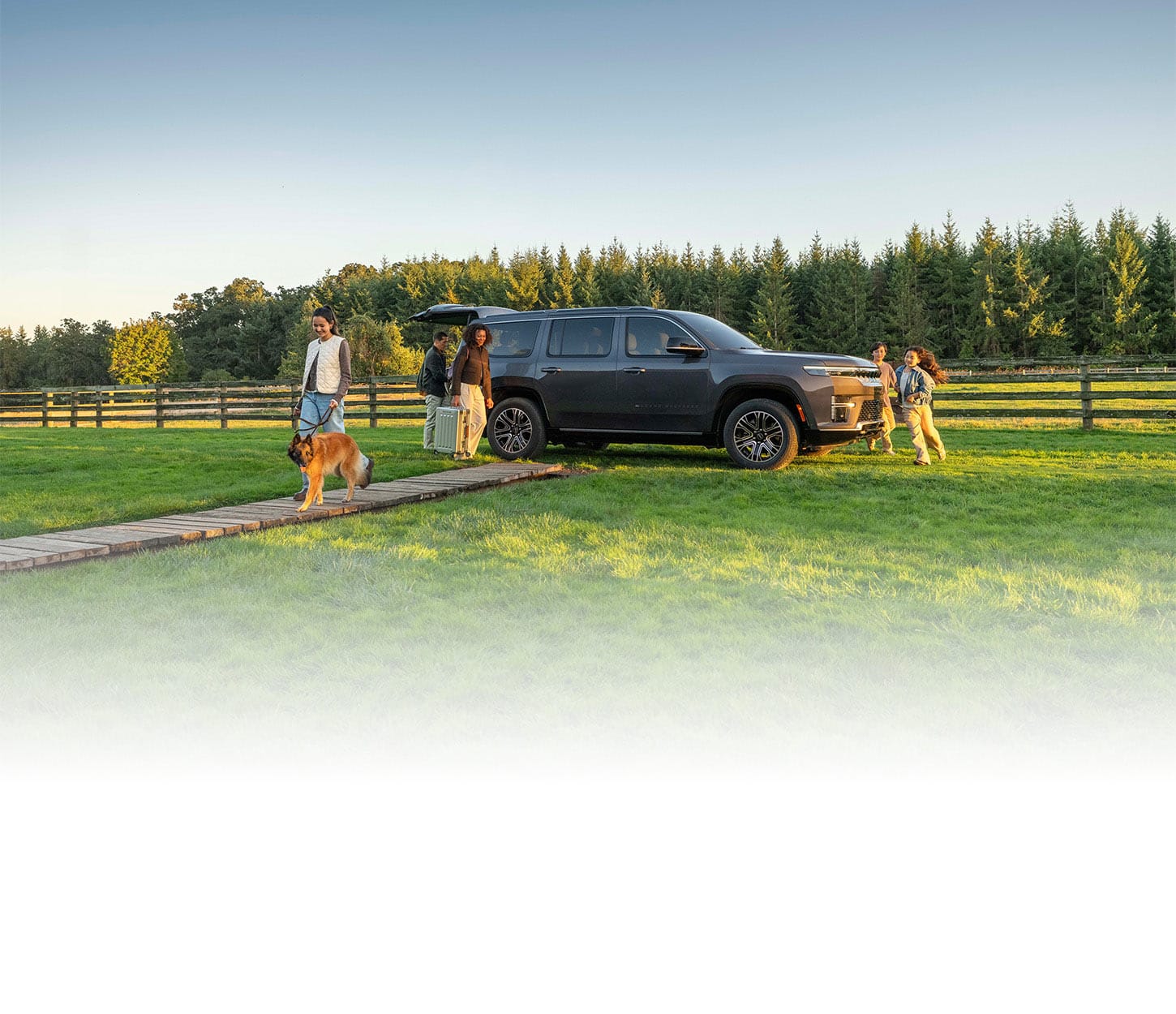 2027 Jeep Grand Wagoneer with a family in a countryside setting