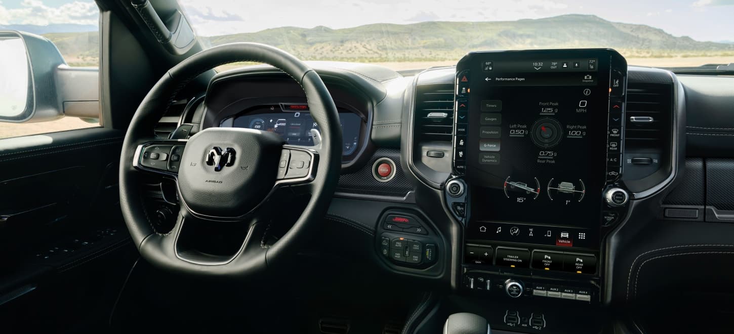 The steering wheel, Digital Cluster Display, Uconnect touchscreen and center stack controls in the 2027 Ram 1500 RHO 4x4 Crew Cab.