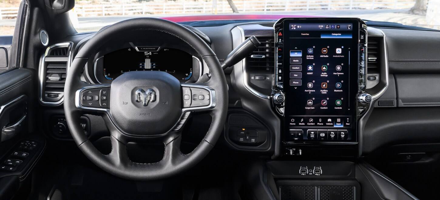 The steering wheel, Digital Cluster Display and Uconnect touchscreen in a 2027 Ram 3500 Heavy Duty Laramie 4x4 Crew Cab pickup truck.