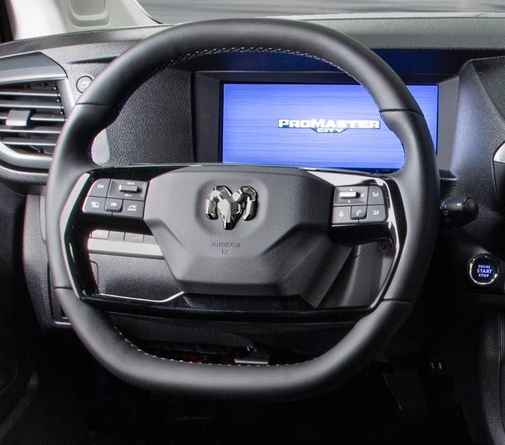 The steering wheel, Digital Cluster Display and AM/FM HD touchscreen radio with Nav in the 2027 Ram ProMaster City Tradesman Van.